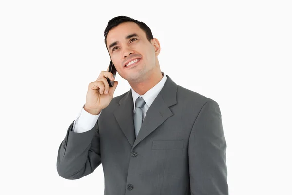 Бизнесмен по телефону смотрит вверх — стоковое фото