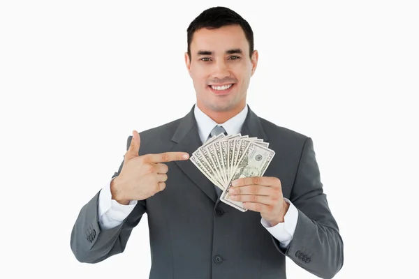 Empresário apontando notas bancárias — Fotografia de Stock