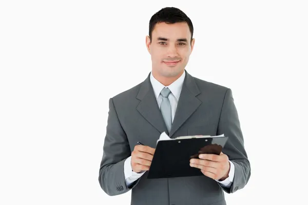 Businessman with clipboard and pen — Stock Photo, Image