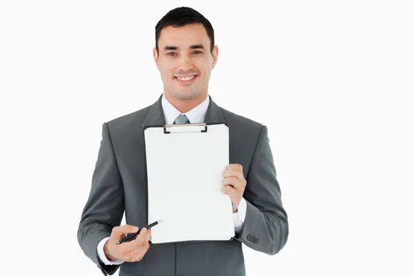 Businessman pointing with pen on clipboard — Stock Photo, Image