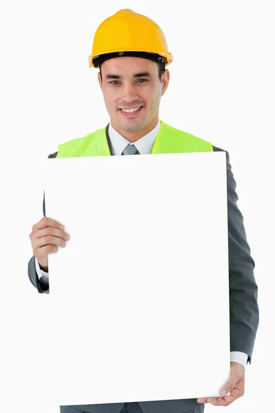 Smiling architect holding sign — Stock Photo, Image