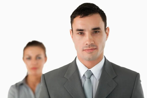 Close up of serious looking businessman with colleague behind hi — Stock Photo, Image