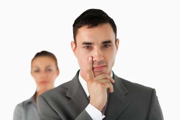 Close up of young businessman with colleague behind him — Stock Photo, Image