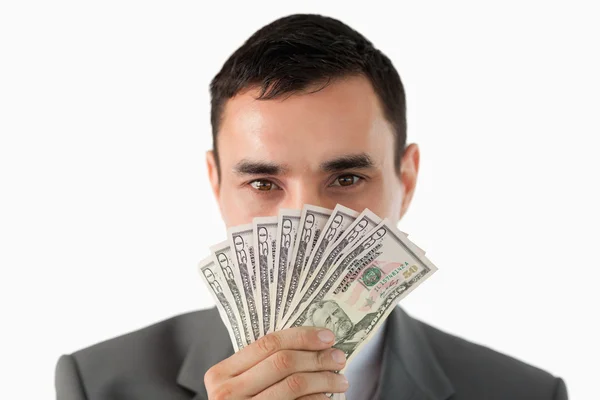 Podnikatel vonící na bankovky — Stock fotografie
