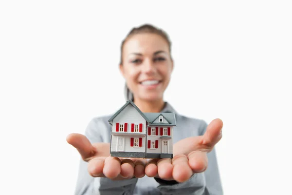 Miniature house being presented by female estate agent — Stock Photo, Image
