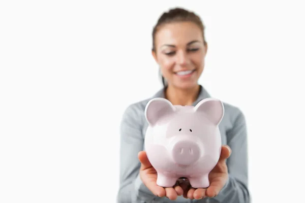 Piggy bank being held by female bank assistant — Stock Photo, Image