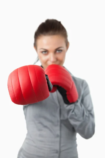 Boxing gloves used to slam by businesswoman — Stock Photo, Image