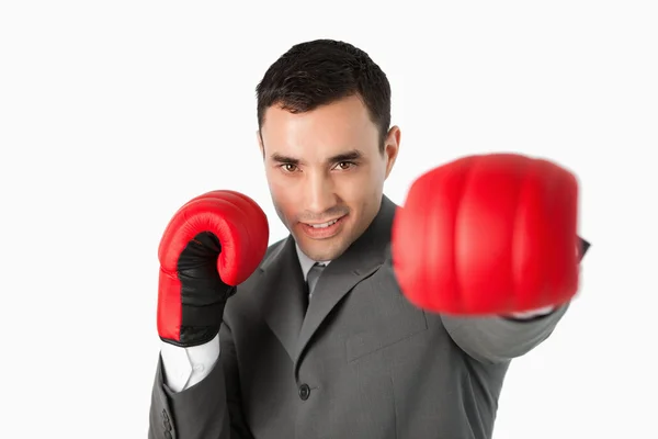 Businessman with boxing gloves on beating — Stock Photo, Image