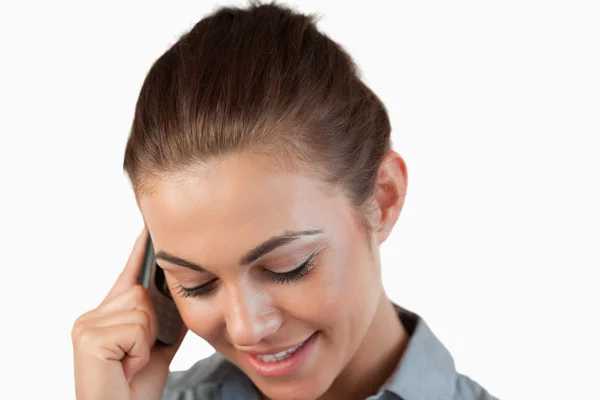 Close up of shy smiling businesswoman on the phone — Stock Photo, Image