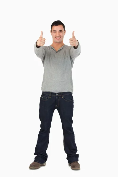 Молодой мужчина делает большие пальцы вверх — стоковое фото