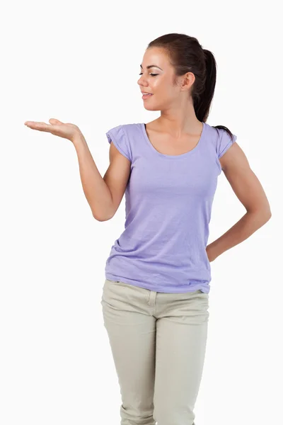 Young female looking at what she is presenting — Stock Photo, Image