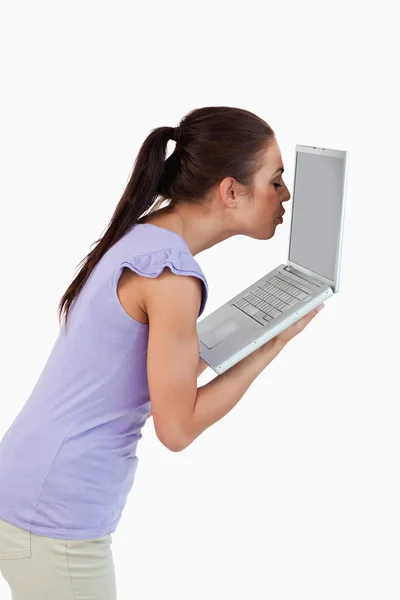 Young female kissing laptop screen — Stock Photo, Image