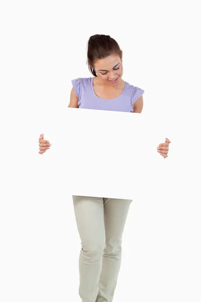 Young female looking at banner in her hands — Stock Photo, Image