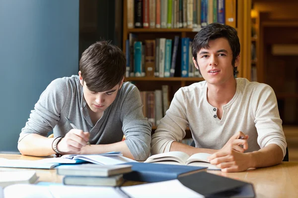 Handsome students reviewing their notes — Stock Photo, Image