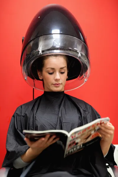 Portrait of a student under a hairdressing machine Stock Photo
