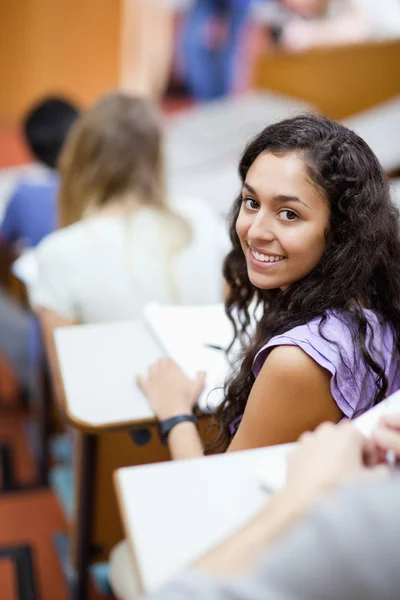 Portrait of a smiling student being distracted — Stock Photo, Image