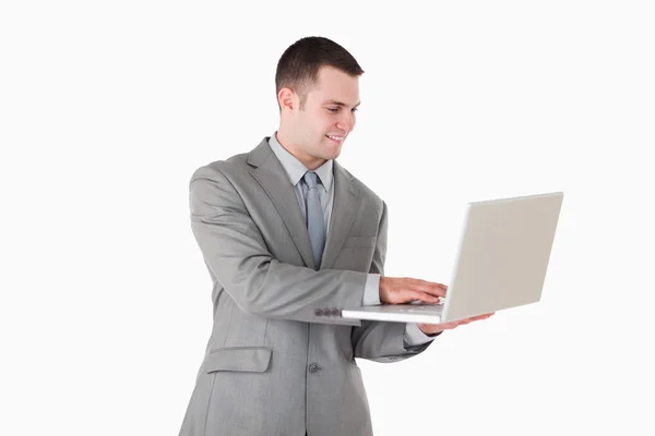 Uomo d'affari che lavora con un computer portatile Foto Stock Royalty Free