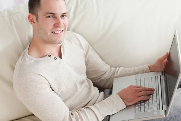 Young man relaxing with a notebook Royalty Free Stock Photos