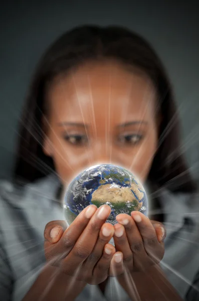 Woman holding a glowing Earth Royalty Free Stock Images