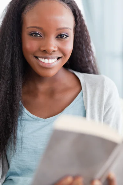 Close up of smiling woman reading Stock Image