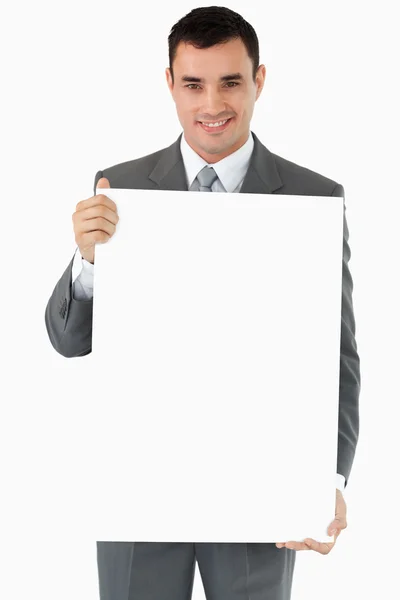 Businessman presenting sign Stock Picture