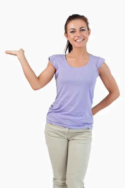 Smiling young female presenting Stock Picture