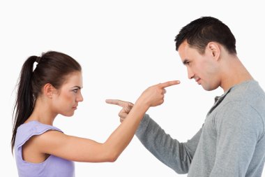 Young couple pointing at each other clipart