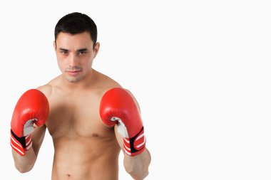 Confident young boxer in fighting stance clipart