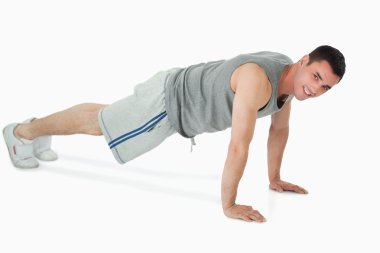 Side view of man doing push ups clipart