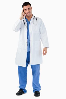 Portrait of a doctor making a phone call clipart