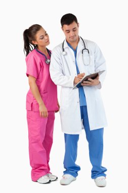 Portrait of a doctor and a nurse taking notes clipart