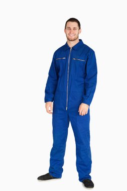 Smiling young mechanic in boiler suit clipart