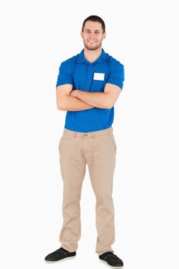 Smiling young salesman with arms folded clipart
