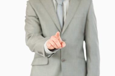 Businessman's finger activating futuristic touchscreen clipart