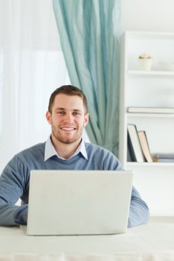 Smiling businessman in his homeoffice clipart