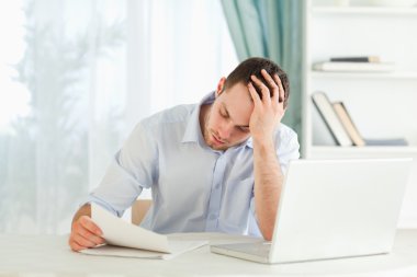 Businessman reading an alarming letter clipart