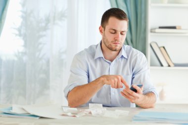 Businessman typing on his calculator clipart