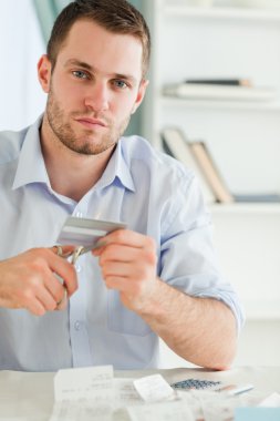 Businessman has to get rid of his credit card clipart