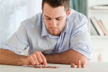 Businessman counting his small change clipart