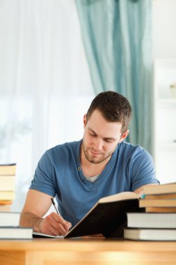 Male student preparing book report clipart