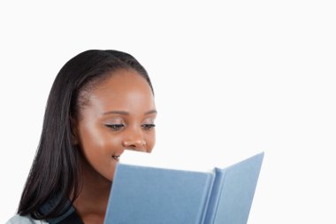 Side view of young woman reading a book clipart