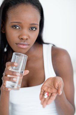 Close up of a woman taking pills clipart