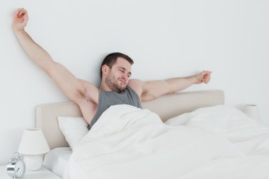 Young man stretching his arms clipart