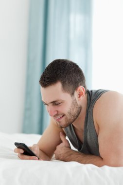 Portrait of a young man using his mobile phone clipart