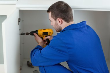 Handyman fixing a door clipart