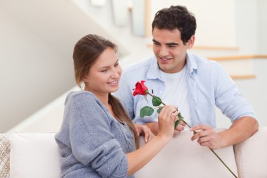 Man offering a rose to his fiance clipart