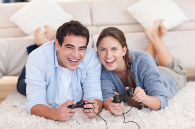 Delighted couple playing video games clipart