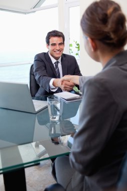 Portrait of a manager interviewing a female applicant clipart