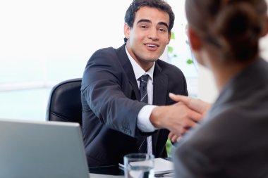 Smiling manager interviewing a female applicant clipart