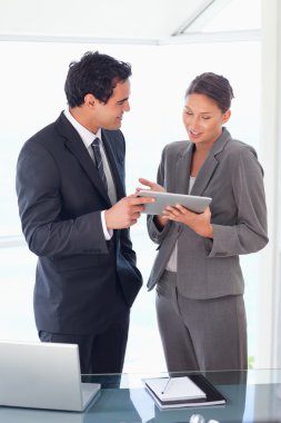 Business partner looking at tablet in their hands clipart